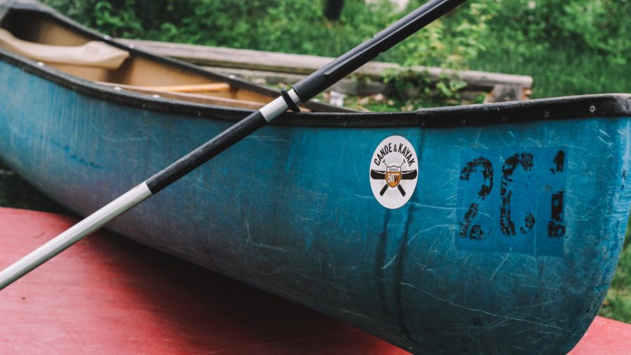 a blue canoe on the shore at Fifty West Canoe and Kayak