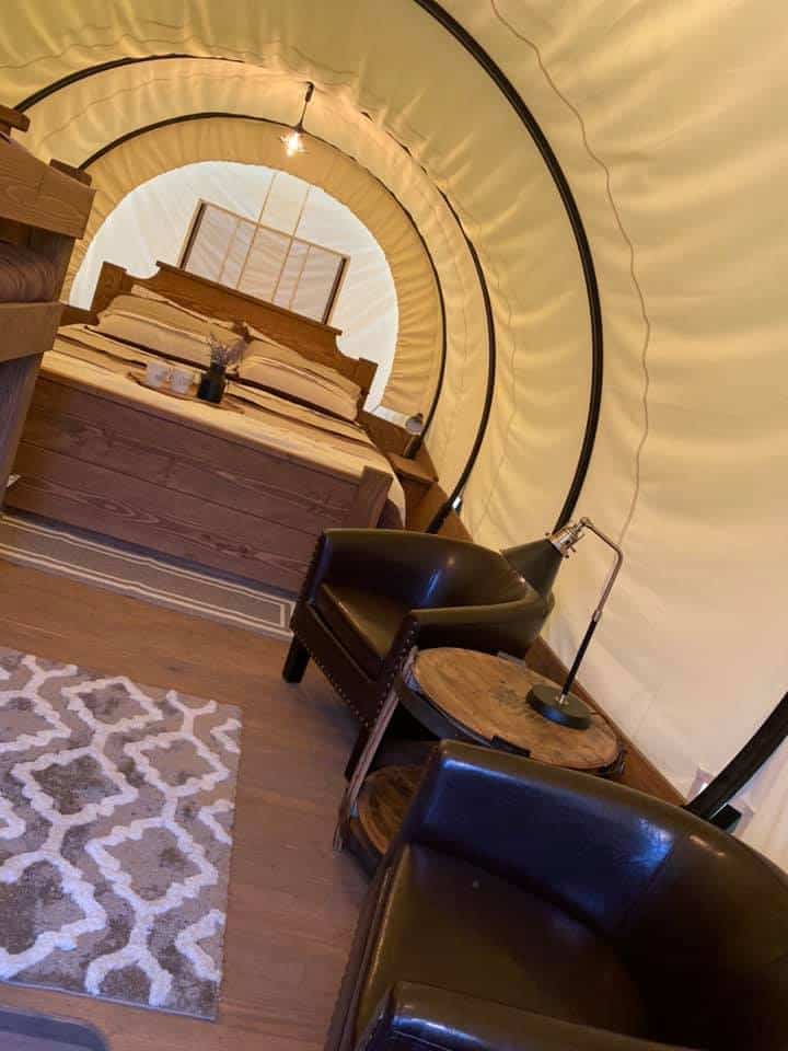 inside one of the covered wagon camping options at Horse Cave KOA
