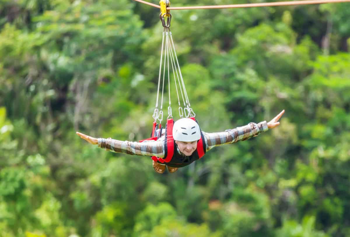 Man on zipline with arms outstretched
