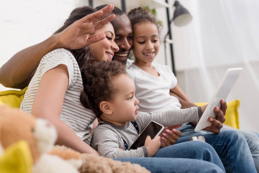 Family having a virtual visit with electronic devices