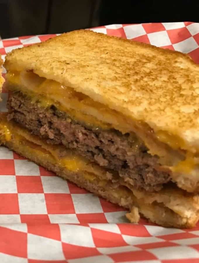 A cheeseburger and grilled cheese sandwich 
