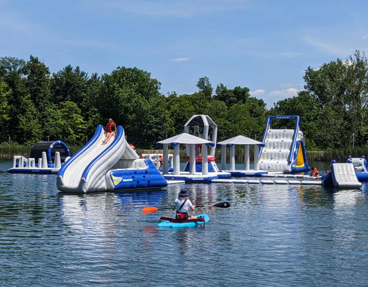 People enjoying inflatables on the lake