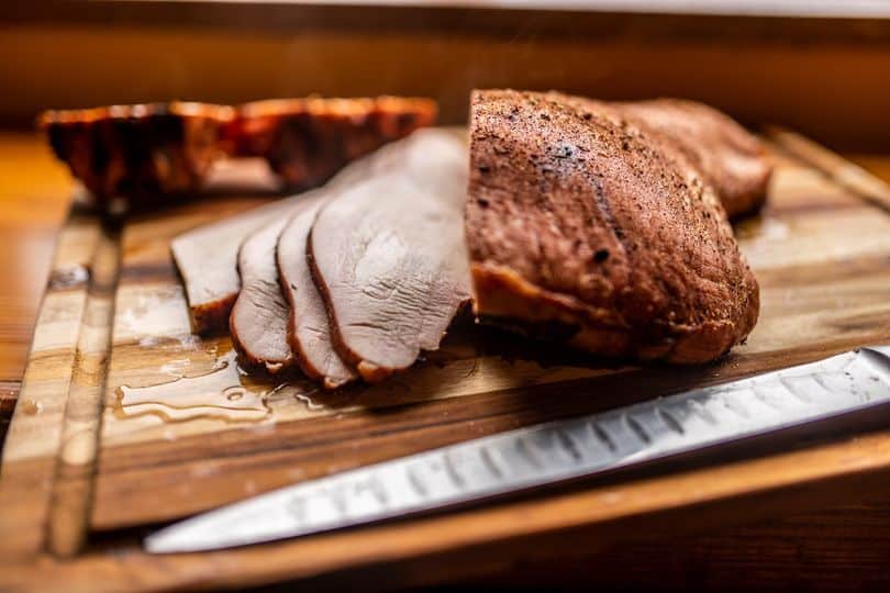 sliced meat on a cutting board
