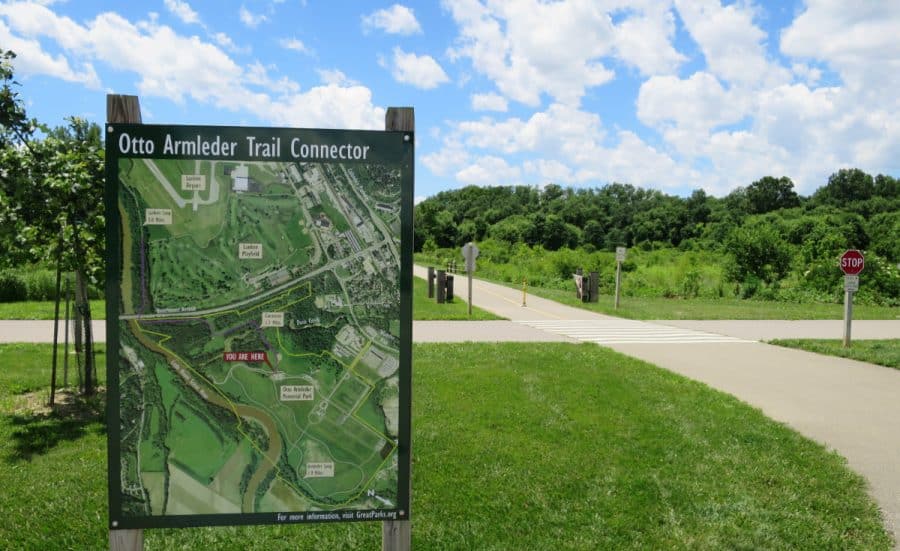 Signage for the Otto Armleder Trail Connector with bike trails in the background