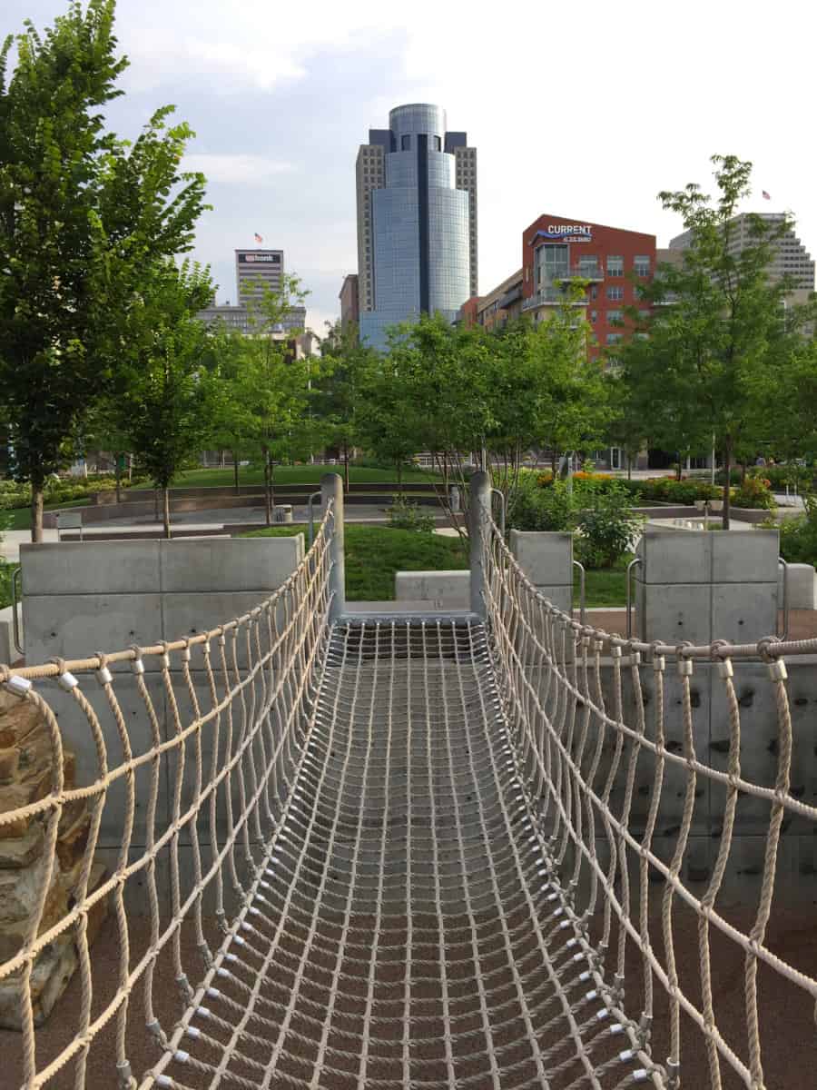 the rope bridge at Great Adventure Playground in front of the Cincinnati skyline