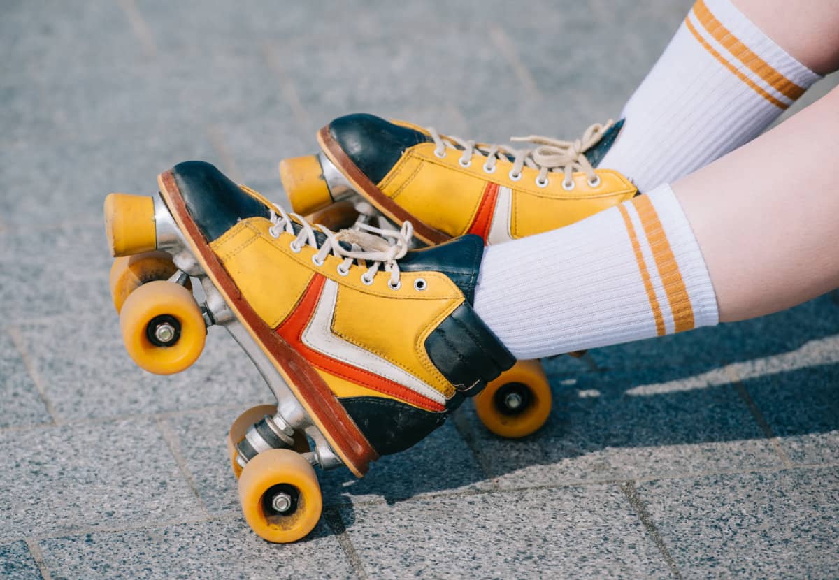 colorful rollers skates on the feet of a person