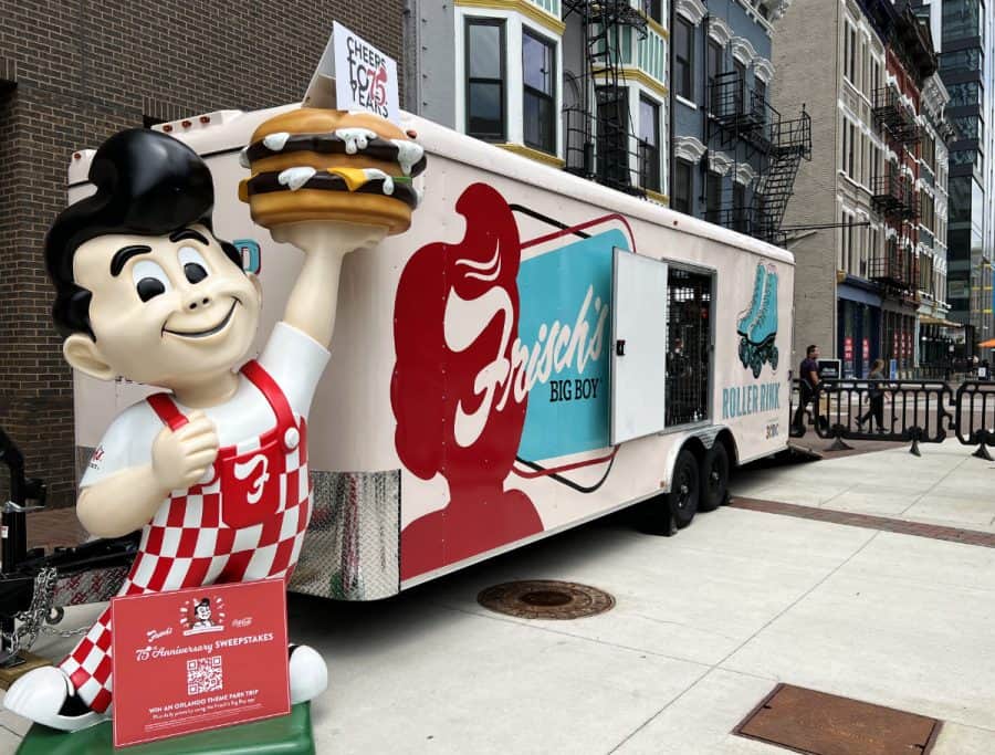 A mobile trailer full of roller skates and a large Big Boy statue