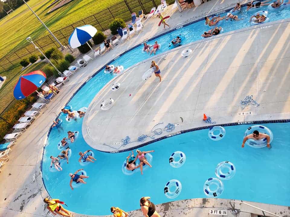 the lazy river with people in floats at Freedom Springs Greenwood Aquatics Park
