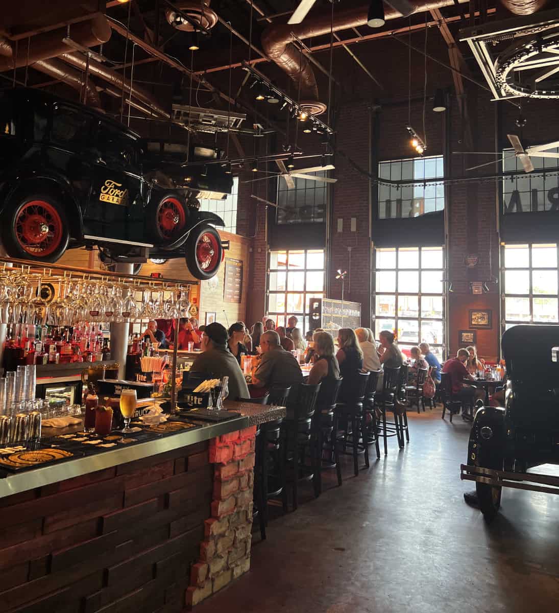 The bar and some cars inside at Ford's Garage in Cincinnati