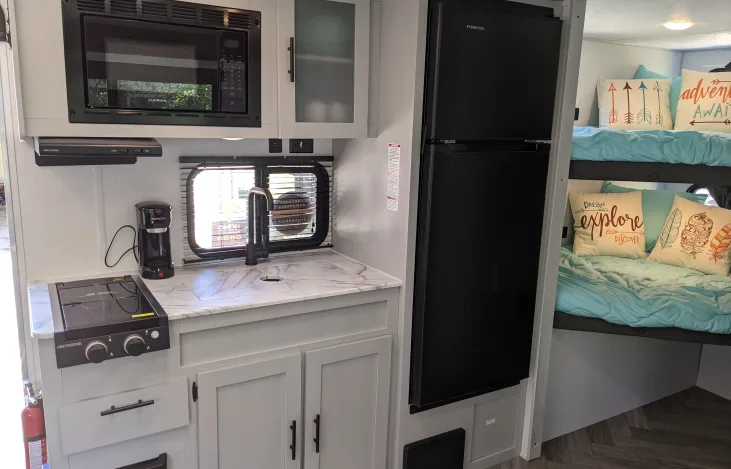 RV kitchen with bunk beds
