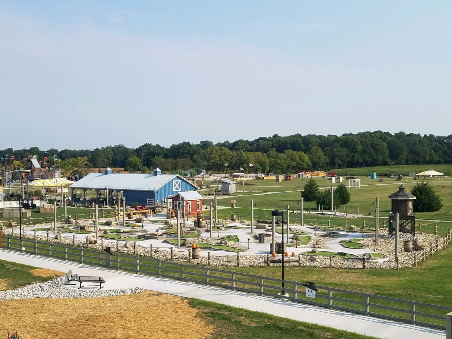 a large field with all sorts of fall fun activities include a mini golf course
