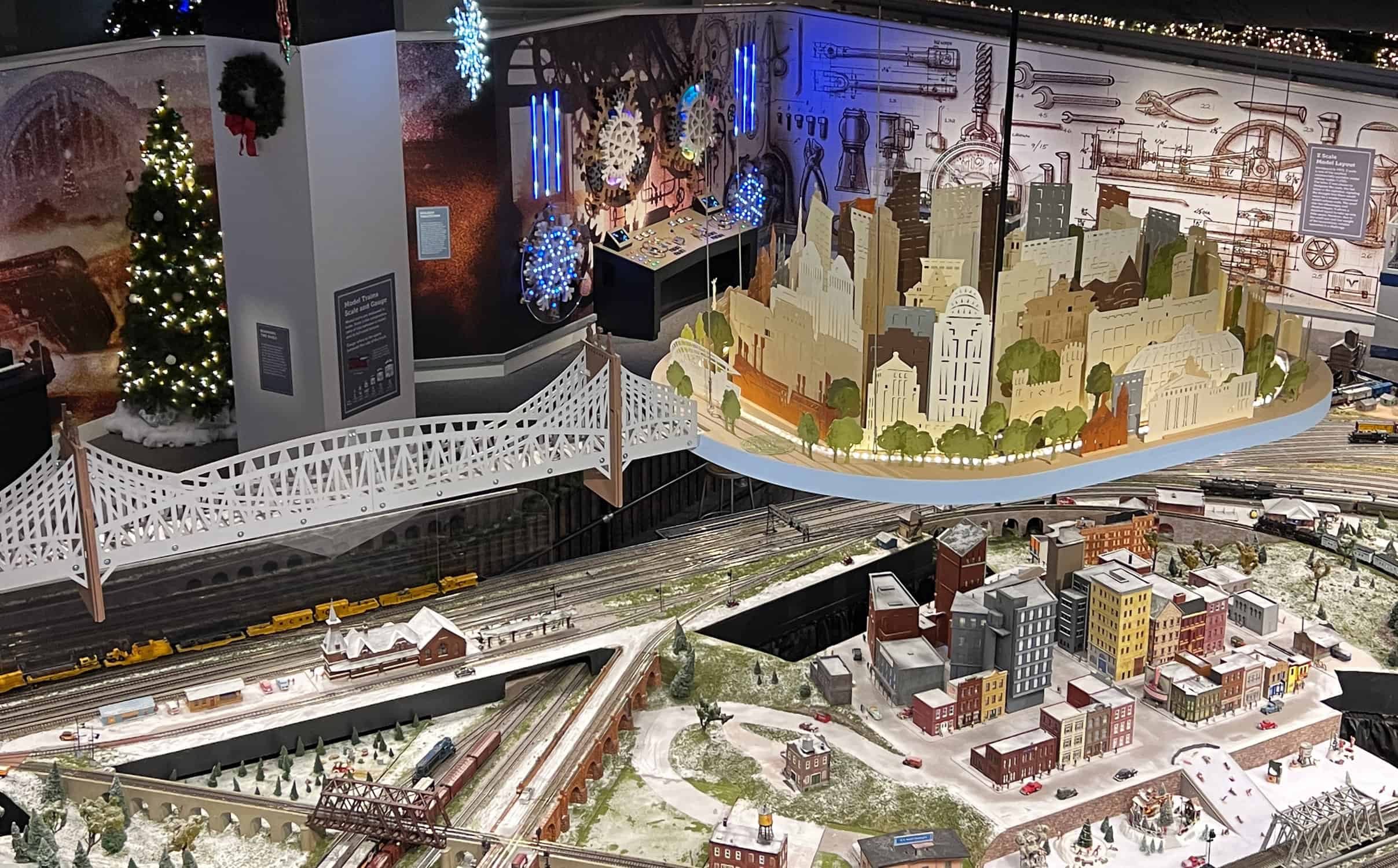 an overhead look at the Duke Energy Train set up and the Cincinnati skyline hanging above