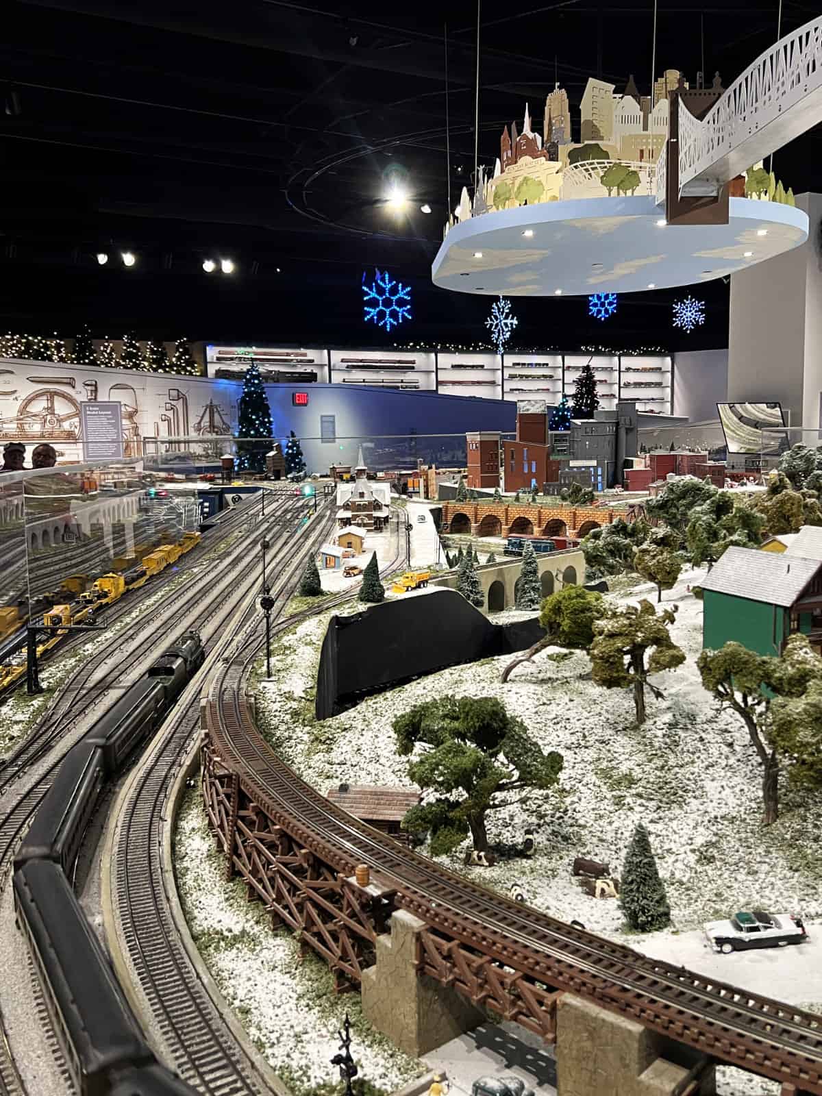 Train tracks, toy locomotive, and city scenes at Cincinnati Museum Center