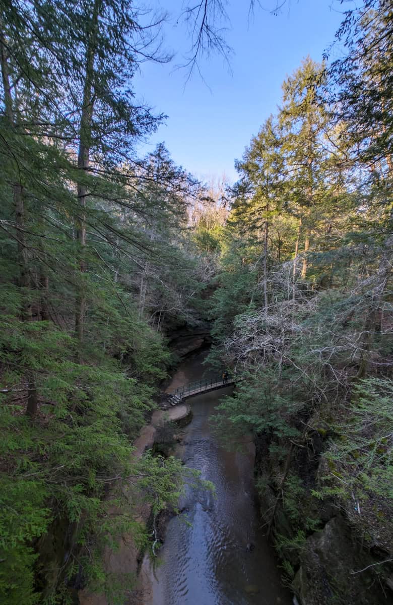 A forest view with stream and blue skies at Hocking Hills State Park
