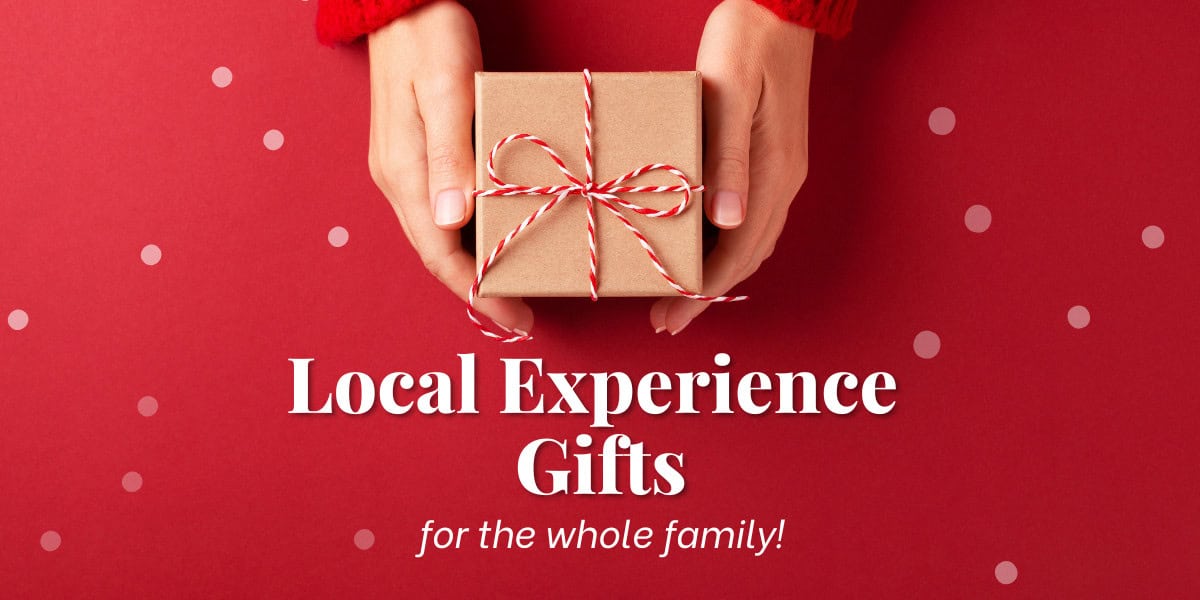 hands holding a brown paper wrapped package as part of an image for Local Experience Gifts Guide