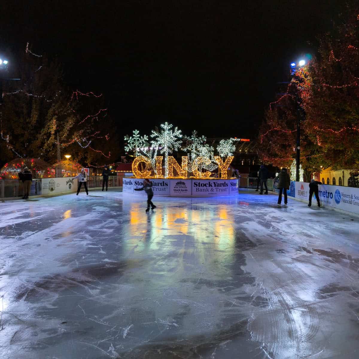 people ice skating at night and a large "Cincy" sign at Cincinnati Christkindlmarkt